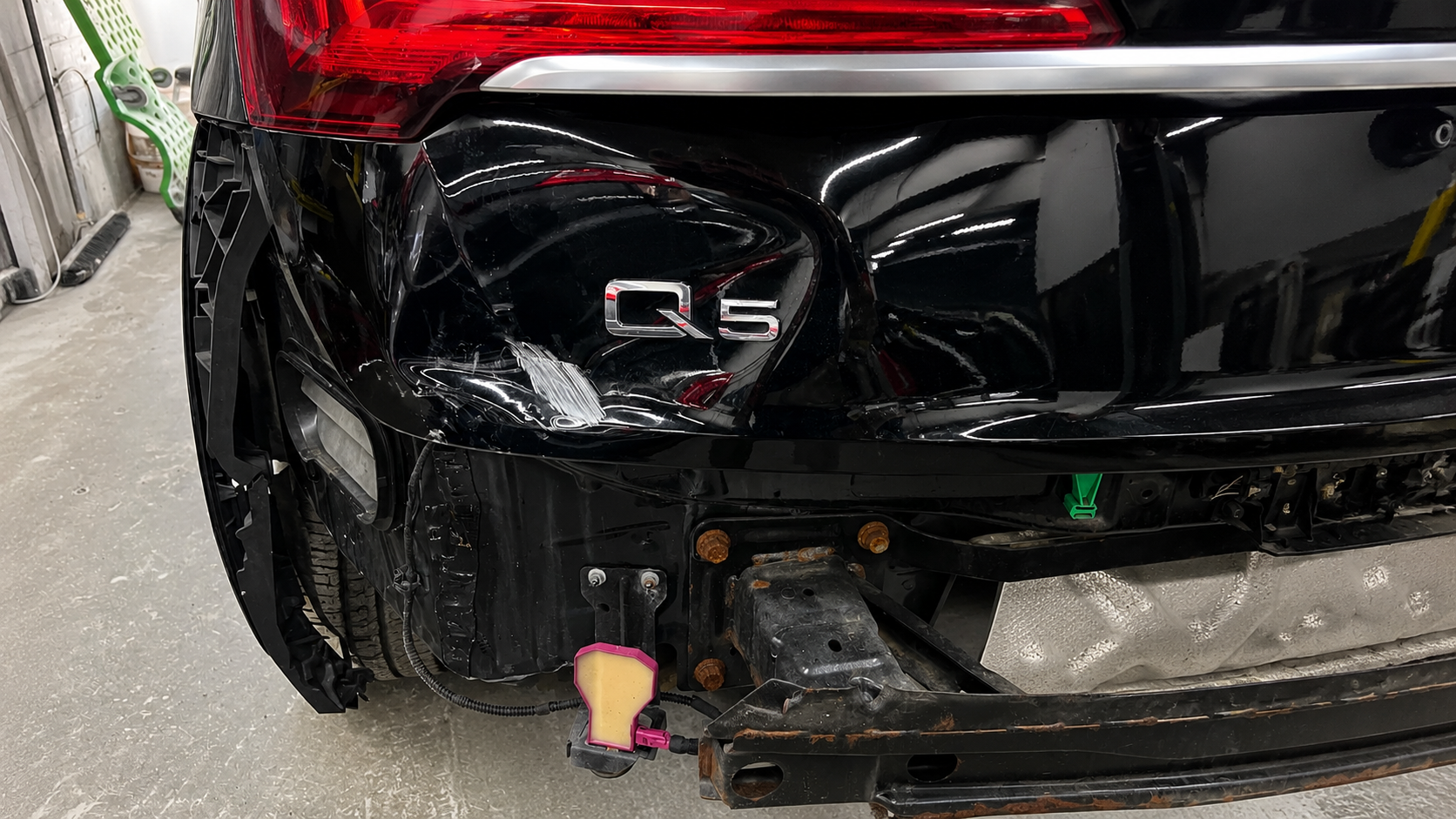 Before rear-end collision repair of a black Audi Q5 showing dented quarter panel and damaged bumper at WL Auto Collision in Brockton, Massachusetts.