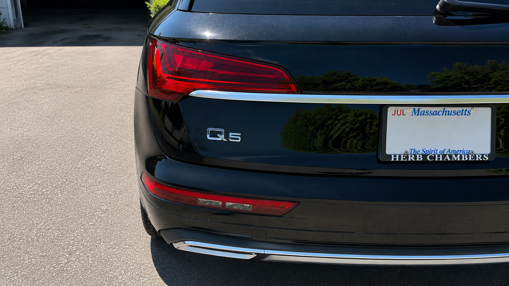 Completed rear-end collision repair of a black Audi Q5 with restored quarter panel, bumper and factory-matched paint at WL Auto Collision in Brockton, Massachusetts.