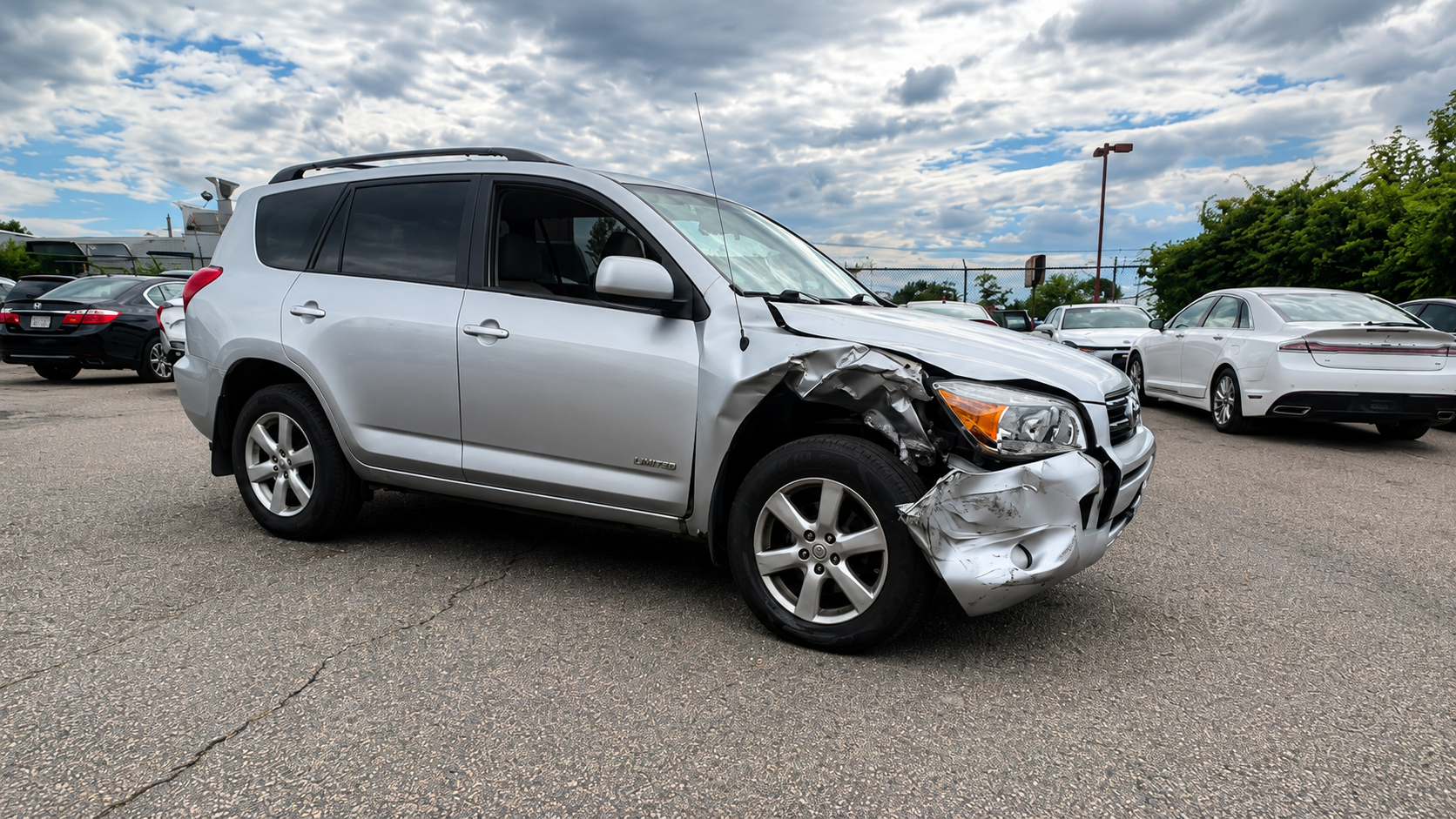 Before collision repair of a silver Toyota RAV4 at WL Auto Collision in Brockton, Massachusetts.